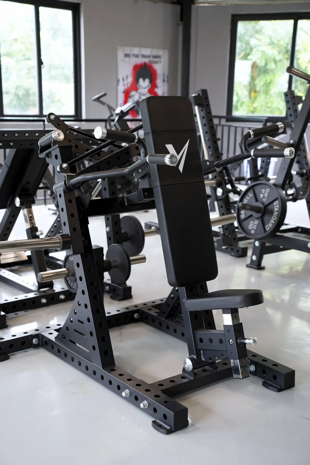 Scissor shoulder press machine on the LEGION IX training floor