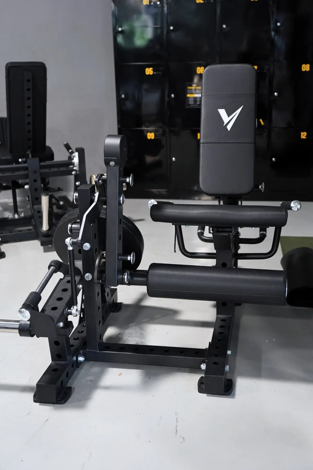 Seated leg extension and lying leg curl combo machine on the LEGION IX training floor